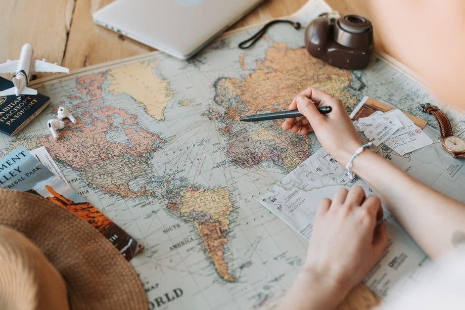 Traveler planning routes on an illuminated world map